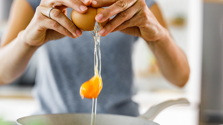 cracking eggs into bowl