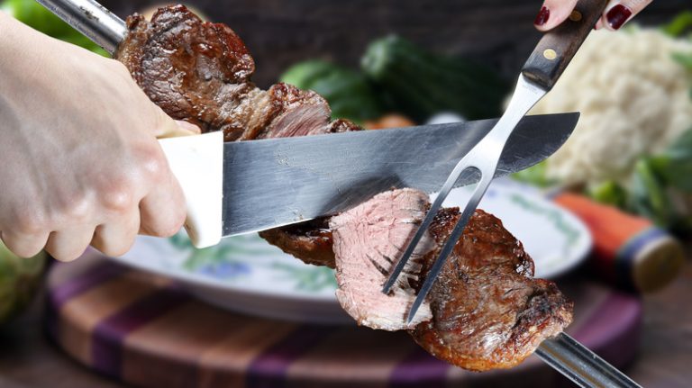 cutting picanha from a spit